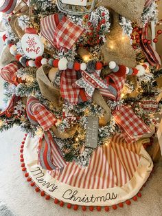 a christmas tree decorated with red and white ribbon