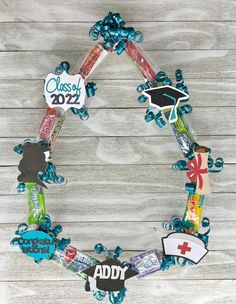 a wreath made out of candy and graduation decorations