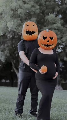 a man and woman dressed up as pumpkins