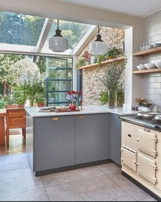 a kitchen with an oven, sink and window