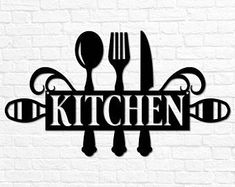 the word kitchen with spoons, knife and fork on a white brick wall background