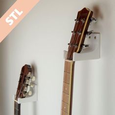 an acoustic guitar hanging on the wall