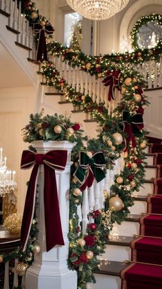 stairs decorated with christmas garland and decorations for the holiday season, along with ornaments on the banister