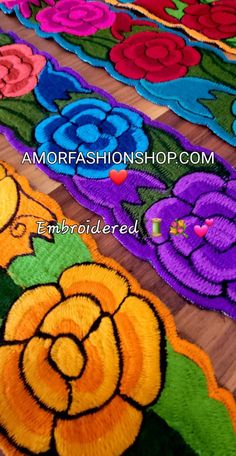 colorful rugs with flowers on them are lined up and ready to be made into wall hangings