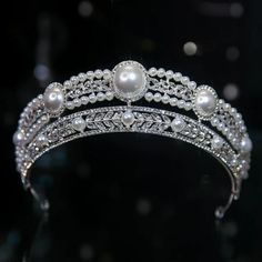 a tiara with pearls and diamonds on it