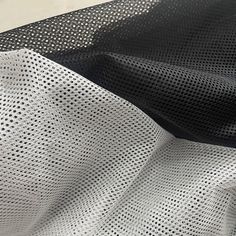 black and white mesh fabric with small holes on the side, as seen from above