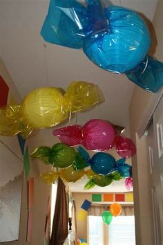 some balloons are hanging from the ceiling in a hallway