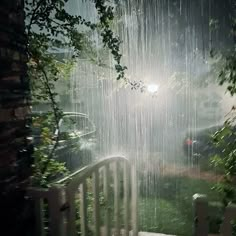 the sun shines through an open window on a rainy day with rain falling down