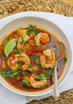 a white bowl filled with shrimp and vegetable soup