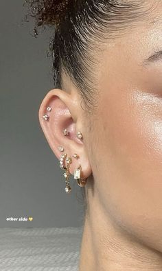 a close up of a person with ear piercings on their ears and behind the ear