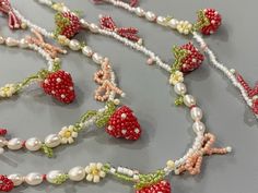 Unique Design: Handcrafted with attention to detail, this necklace features a delightful combination of pearls and strawberry-shaped beads, making it a standout piece. High-Quality Materials: Made with premium pearls and durable beads, ensuring longevity and a luxurious feel. Versatile Accessory: Ideal for adding a touch of whimsy to any outfit, whether you're dressing up for a special occasion or adding a fun element to your everyday look. Perfect for Summer: The vibrant strawberry beads evoke Unique Seed Bead Jewelry, Strawberry Beaded Necklace, Strawberry Beads, Seed Bead Embroidery, Business Jewelry, Beads Making, Beaded Earrings Diy, Summer Necklace, Beaded Bracelets Diy