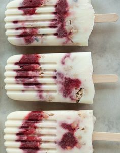 three popsicles covered in white and red toppings