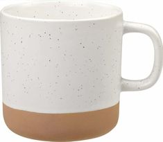 a white and brown coffee mug with speckles on the outside, in front of a white background