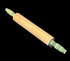 a wooden handle with green handles on a black background