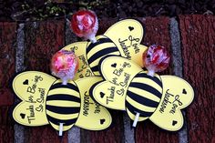 some lollipops are sitting on top of each other in the shape of bees