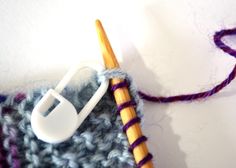 a crochet hook and yarn on a white surface