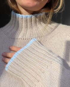 a close up of a person wearing a sweater