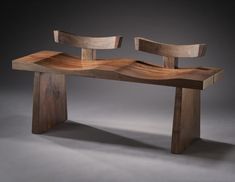 a wooden bench made out of two pieces of wood