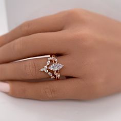 a woman's hand with a diamond ring on it