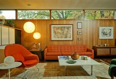 a living room filled with furniture and lots of windows on top of the wall next to each other