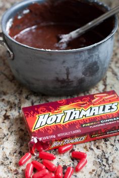 hot tamale candy bar next to a pot of melted chocolate on a granite countertop