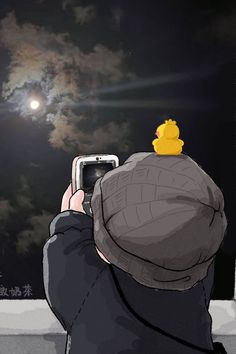 a person is taking a photo with their cell phone at night in front of the moon