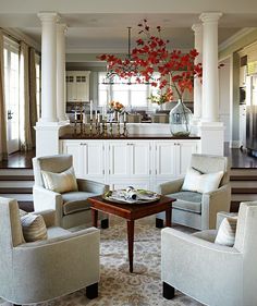 a living room filled with furniture and a bar