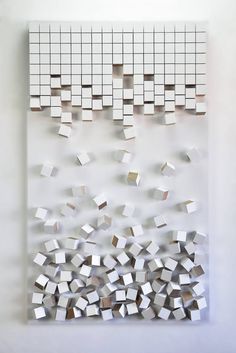 a white wall with many mirrors hanging on it