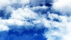 an airplane is flying in the blue sky with white clouds above it and below it