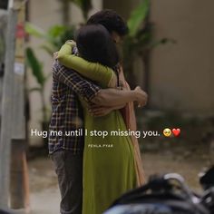 two people hugging each other in front of a building with the caption hug me until i stop missing you