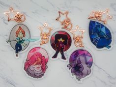 four anime key chains with different designs on them