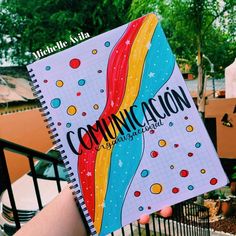 a person holding up a notebook with the words conundacon written on it