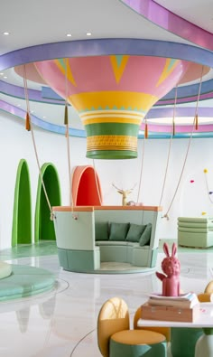 the interior of a children's playroom with colorful furniture