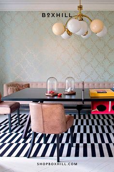 A black outdoor ping pong table placed on a modern dining room set up with 2 brown  chairs and a beige sofa against the wall