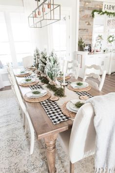 a dining room table set with place settings