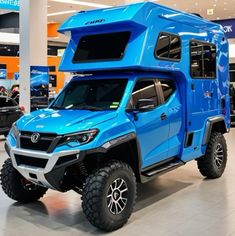 a blue truck is parked in a showroom