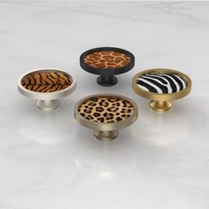 four different types of knobs with animal print designs on the front and back sides