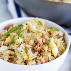 a white bowl filled with rice and vegetables