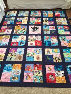 a mickey mouse themed quilt on the floor