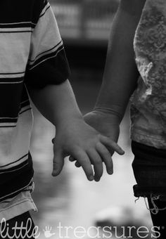 black and white photograph of two children holding hands