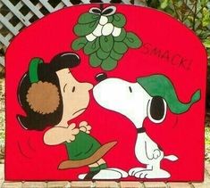 a sign that has a cartoon dog and a person kissing it on the front of it