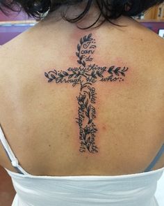 a woman with a cross tattoo on her back