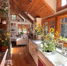 a kitchen with sunflowers and other flowers in it