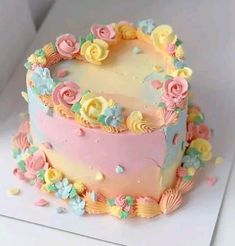 a pink and yellow cake with flowers on it