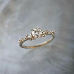 a gold ring with three diamonds on it