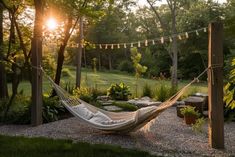 a hammock hanging in the middle of a garden