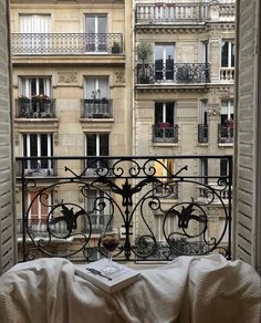 an open window with a view of the city from it's balcony area and balconies