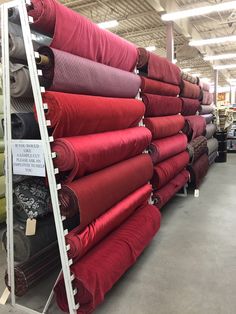 many different colored fabrics on display in a store