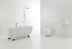 a white bathroom with a bathtub, sink and toilet is shown in this image