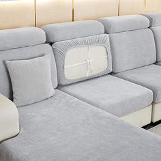 a gray couch with pillows on it in a room